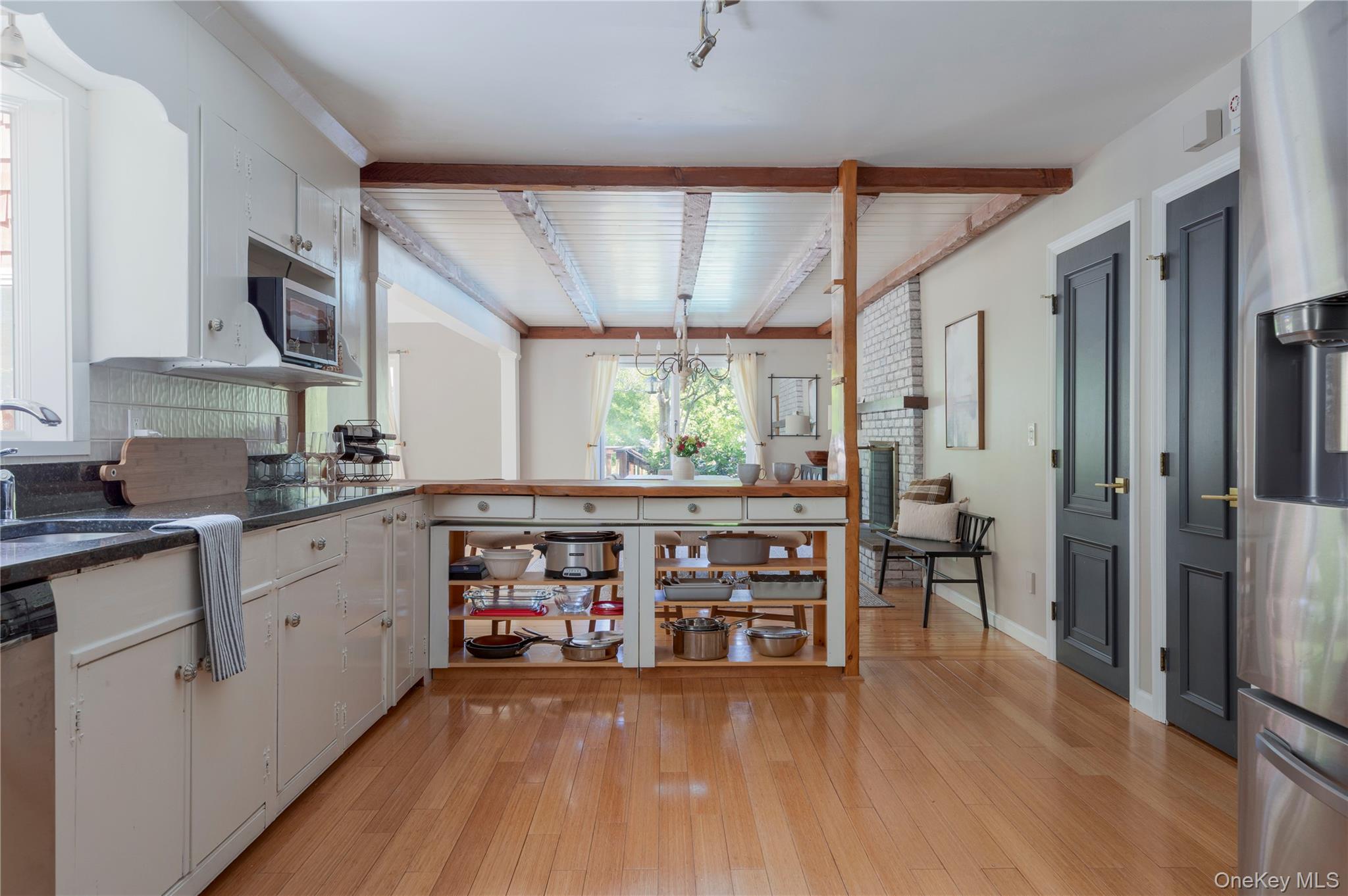 135 Turk Hill Road Brewster, NY 10509 - Photo 10 of 42 a kitchen with stainless steel appliances wooden floors and wooden cabinets