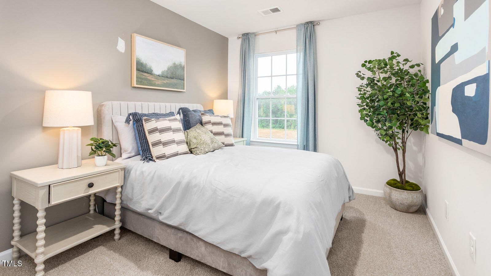 219 Perseus Street Angier, NC 27501 - Photo 19 of 27 a bedroom with a bed and a potted plant