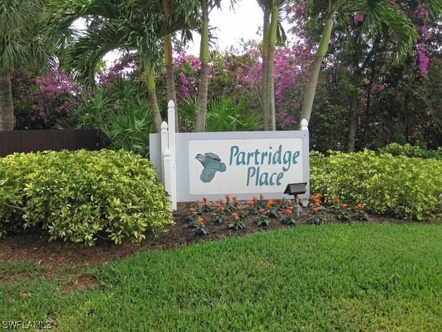 16740 Partridge Place Road Fort Myers, FL 33908 - Photo 8 of 8 a sign of golf club on a wall under a tree
