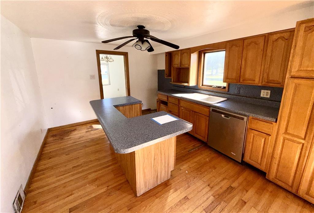 283 Line Street Central City, PA 15926 - Photo 2 of 11 a kitchen with wooden cabinets a sink and dishwasher