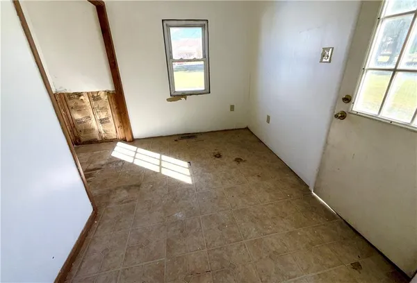 a view of an empty room with windows