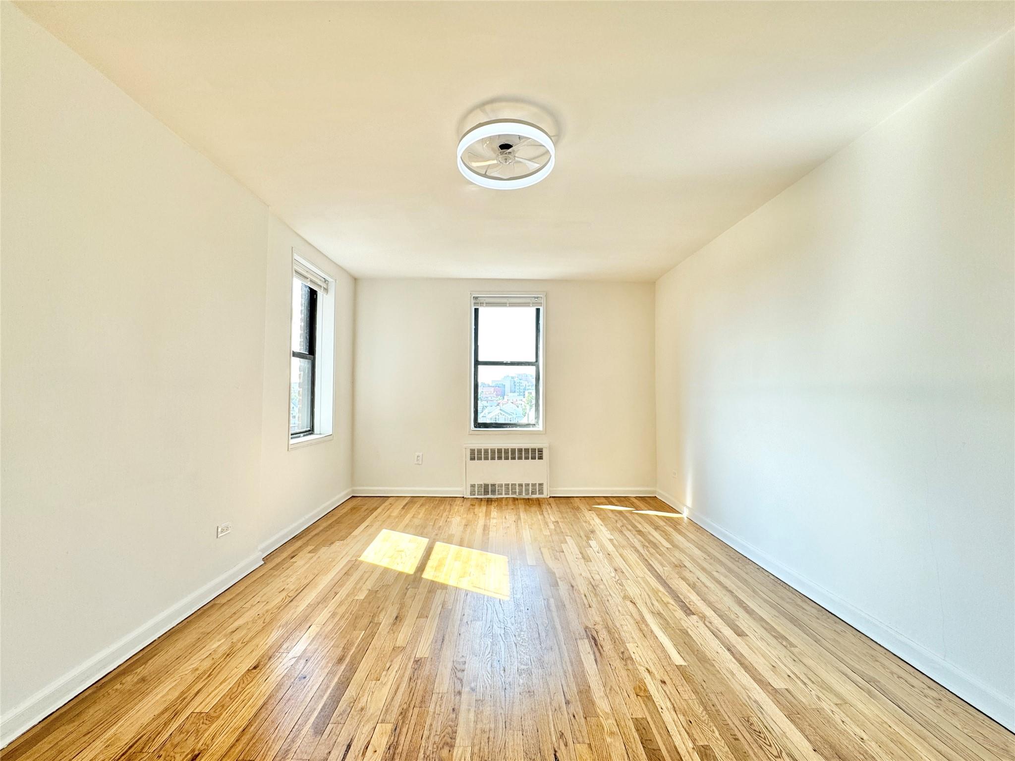 84-19 51st Avenue, Unit 5E Queens, NY 11373 - Photo 2 of 8 a view of a livingroom with wooden floor and window
