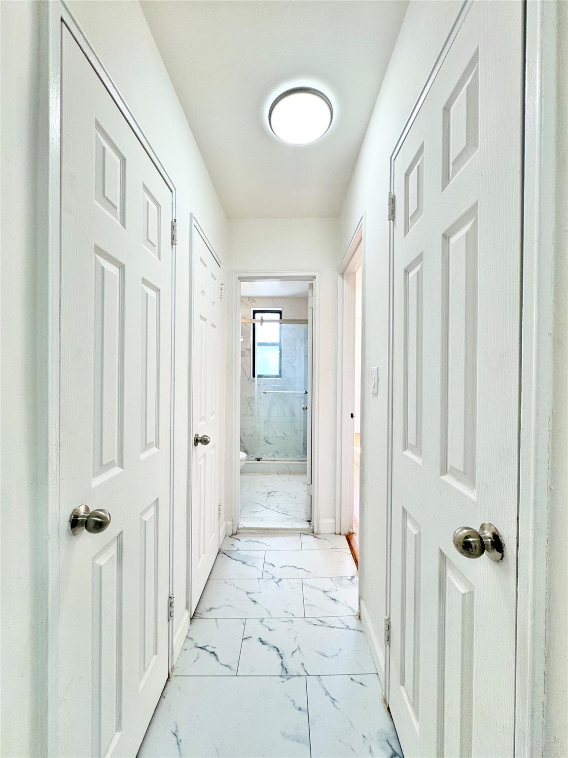 84-19 51st Avenue, Unit 5E Queens, NY 11373 - Photo 4 of 8 a view of a hallway with a elevator