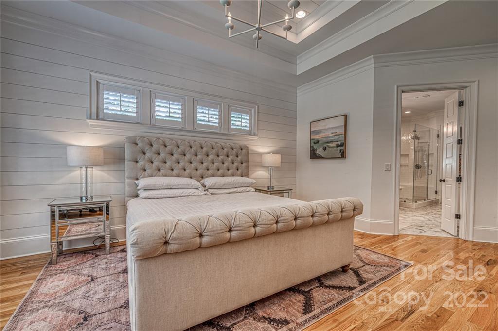 4026 Country Overlook Drive Fort Mill, SC 29715 - Photo 13 of 43 a bedroom with a large bed and a chandelier