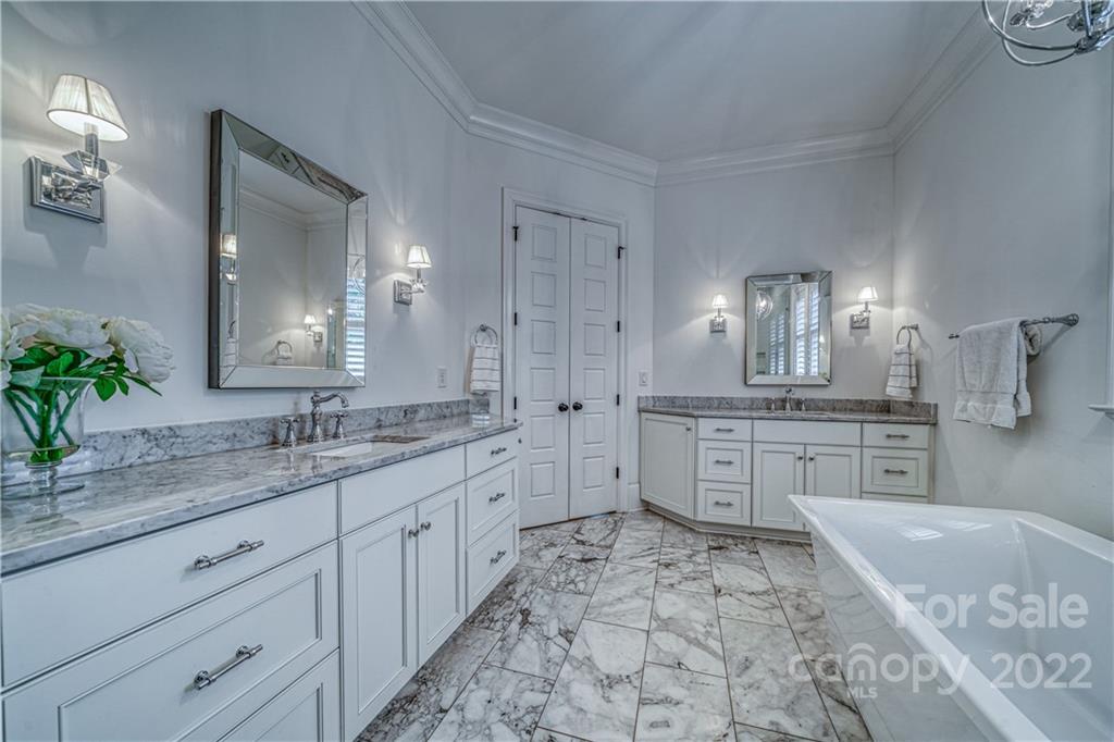 4026 Country Overlook Drive Fort Mill, SC 29715 - Photo 15 of 43 a large bathroom with a granite countertop double vanity sink a mirror and a bathtub