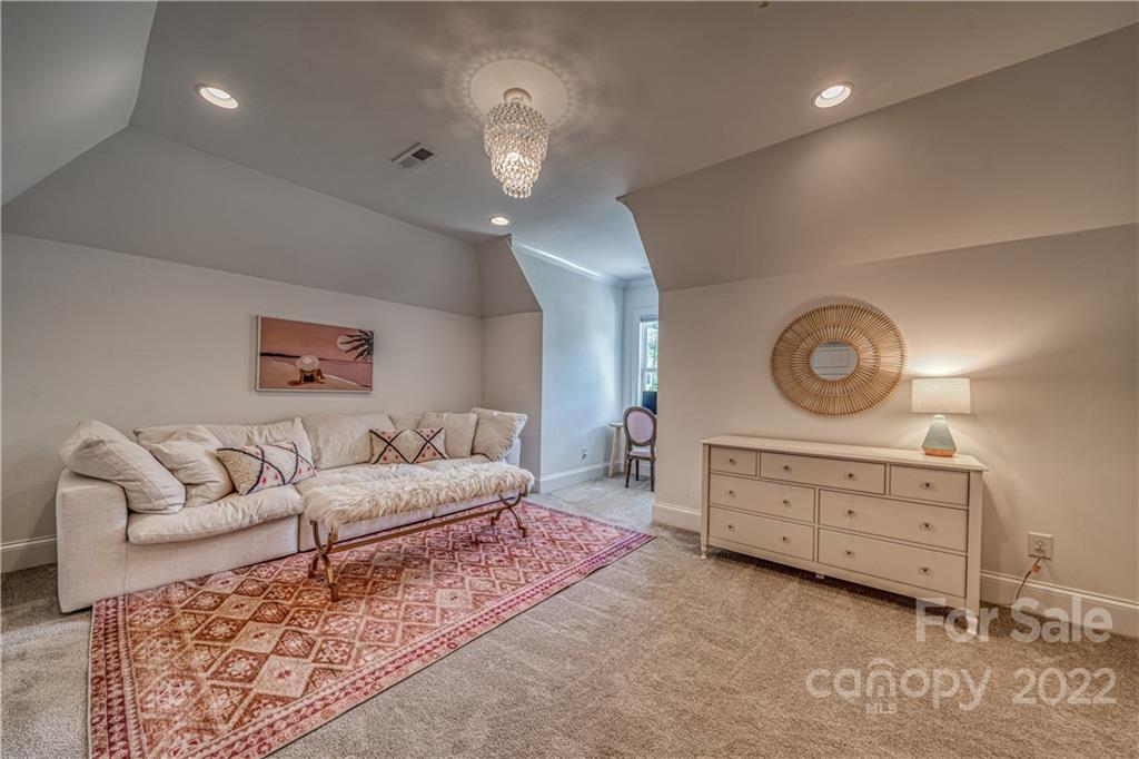 4026 Country Overlook Drive Fort Mill, SC 29715 - Photo 30 of 43 a spacious bedroom with a bed a chandelier and balcony
