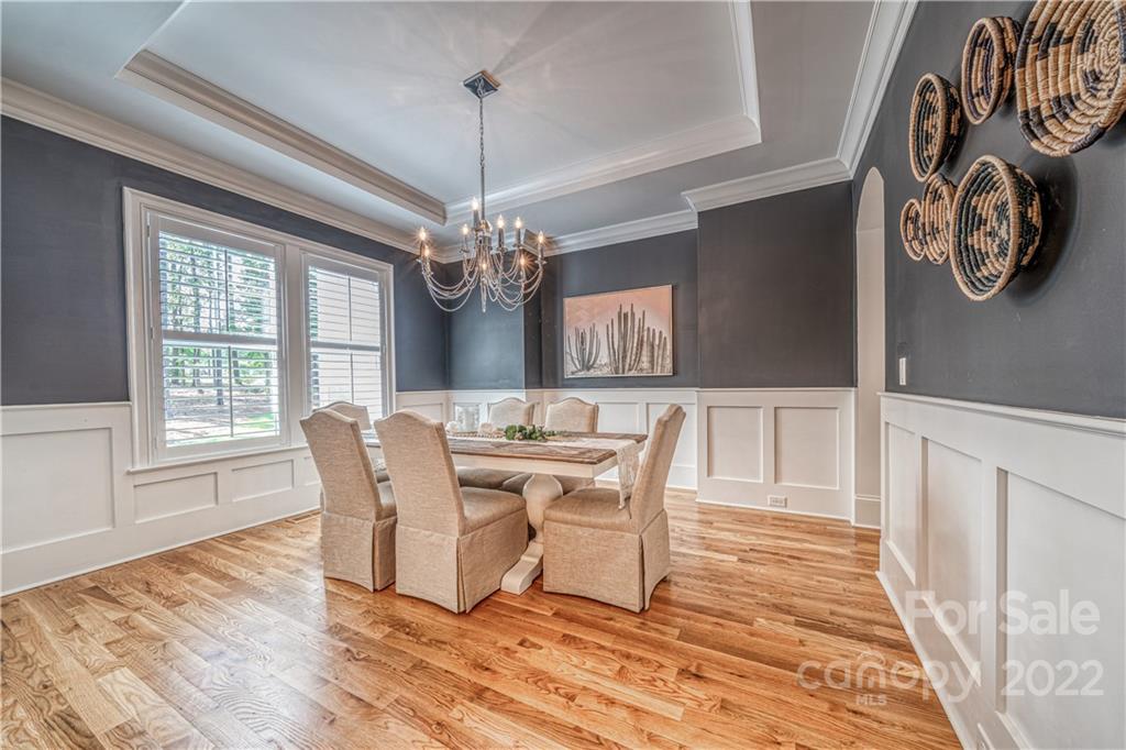 4026 Country Overlook Drive Fort Mill, SC 29715 - Photo 8 of 43 a view of a dining room with furniture a chandelier and wooden floor