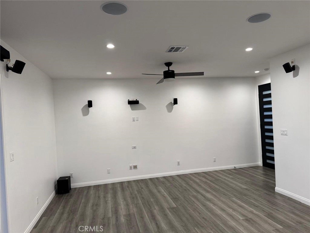 18222 Chatsworth Street Porter Ranch, CA 91326 - Photo 11 of 41 an empty room with wooden floor and cabinets