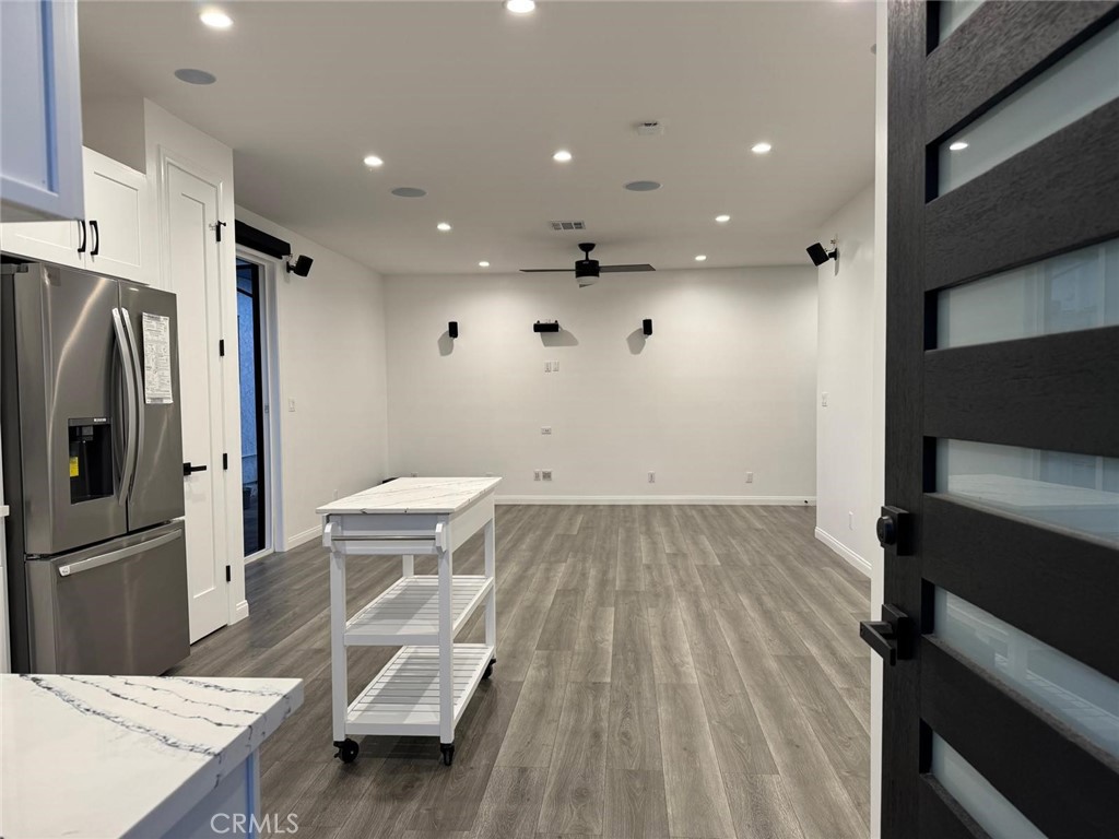 18222 Chatsworth Street Porter Ranch, CA 91326 - Photo 12 of 41 a view of a kitchen with refrigerator and wooden floor