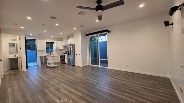 a view of a hall with wooden floor