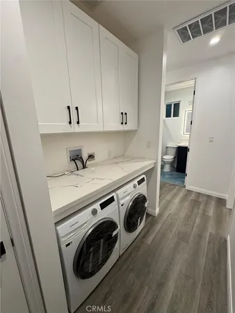a view of a storage and utility room with washer and dryer