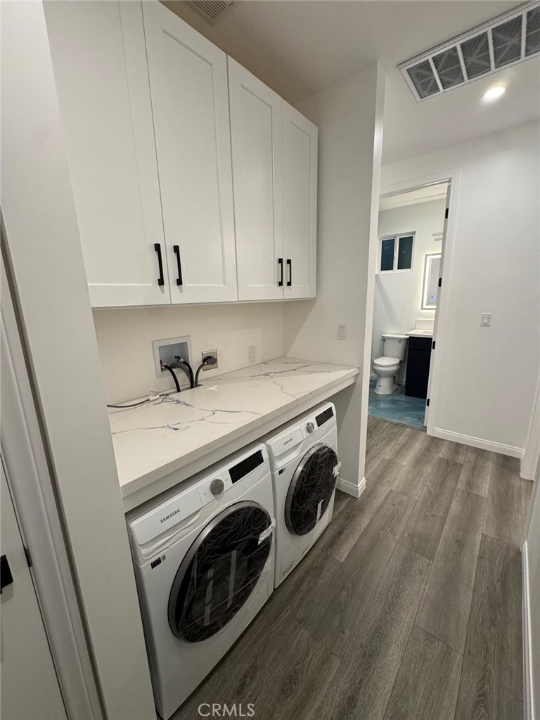 18222 Chatsworth Street Porter Ranch, CA 91326 - Photo 3 of 41 a view of a storage and utility room with washer and dryer