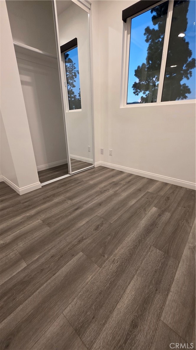 18222 Chatsworth Street Porter Ranch, CA 91326 - Photo 33 of 41 an empty room with wooden floor and window