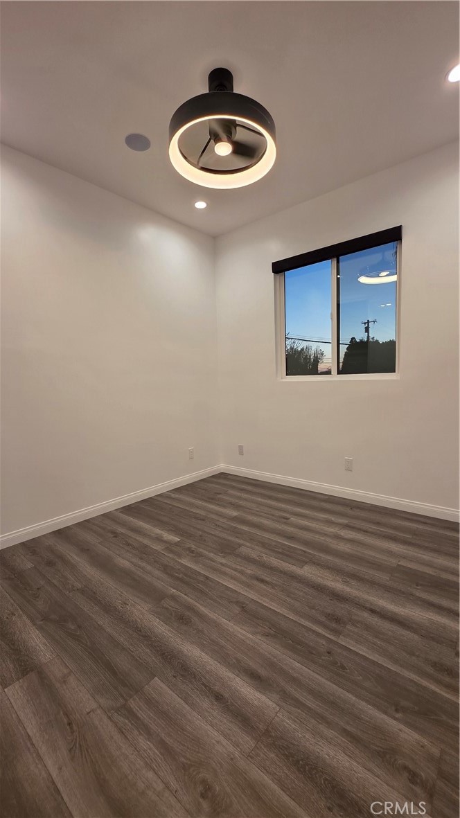 18222 Chatsworth Street Porter Ranch, CA 91326 - Photo 40 of 41 a view of an empty room with wooden floor and a window