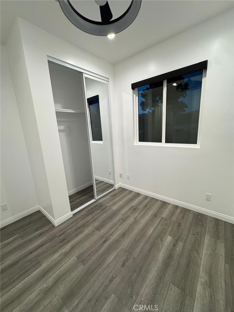18222 Chatsworth Street Porter Ranch, CA 91326 - Photo 4 of 41 an empty room with wooden floor and windows