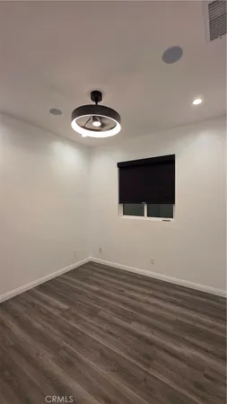 a view of wooden floor and chandelier in a room
