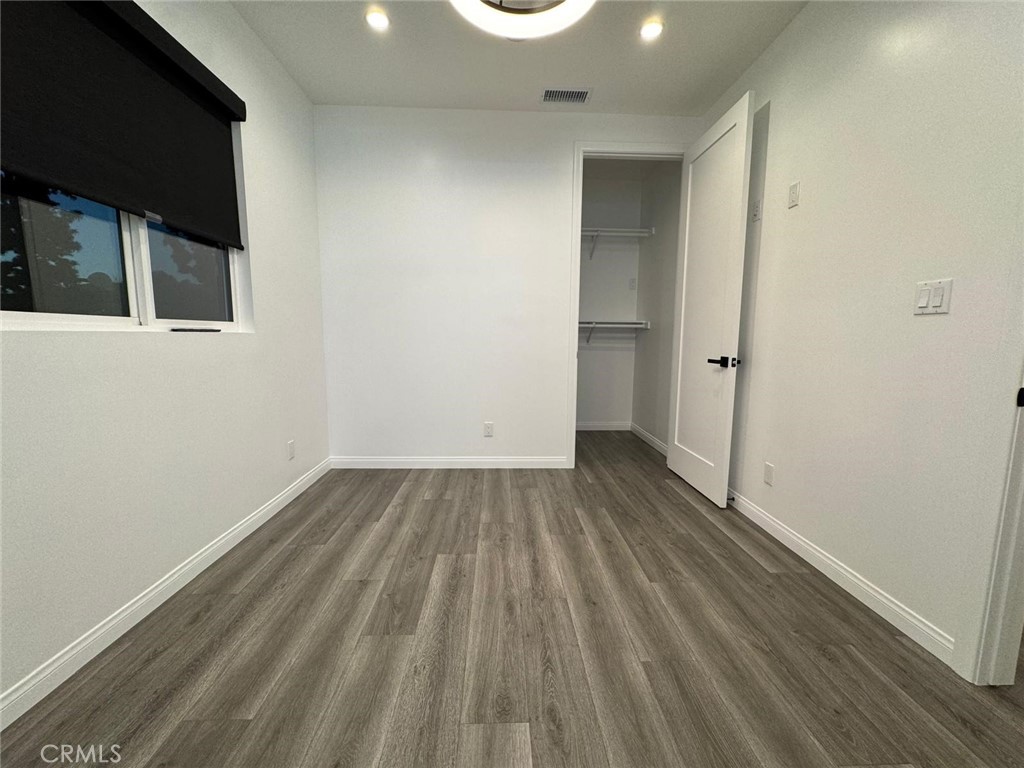 18222 Chatsworth Street Porter Ranch, CA 91326 - Photo 6 of 41 a view of an empty room and wooden floor