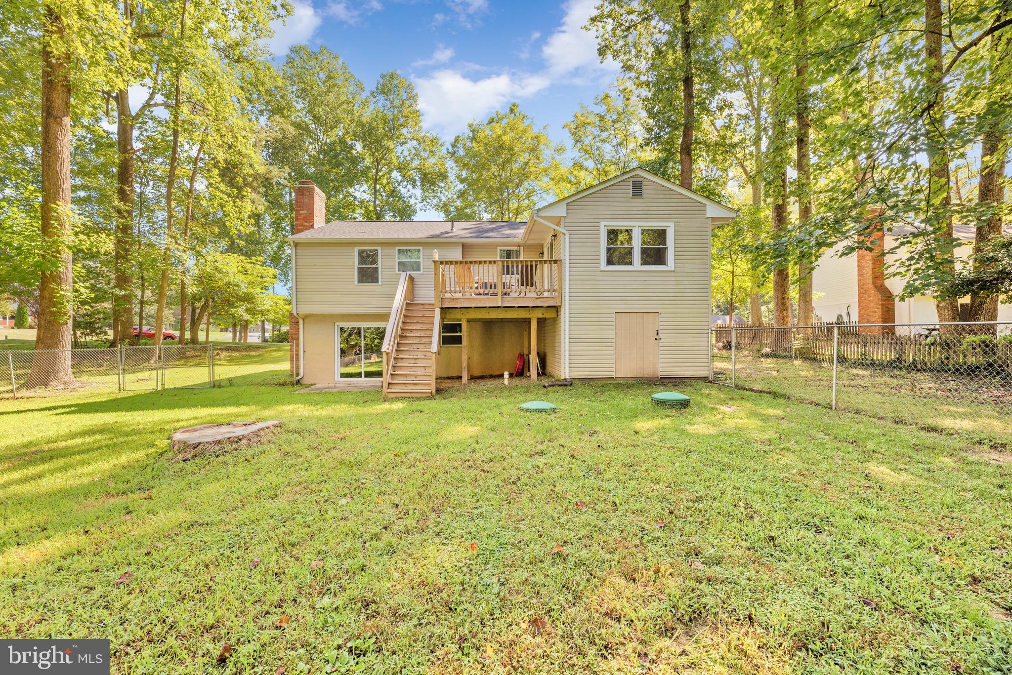 5756 Stephen Reid Road Huntingtown, MD 20639 - Photo 7 of 42 a front view of a house with a garden and yard