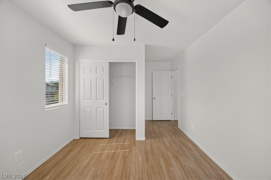 552 Albacate Street Henderson, NV 89015 - Photo 29 of 40 A quiet bedroom offering clean lines, warm-toned laminate flooring, and a useful ceiling fan for comfort.