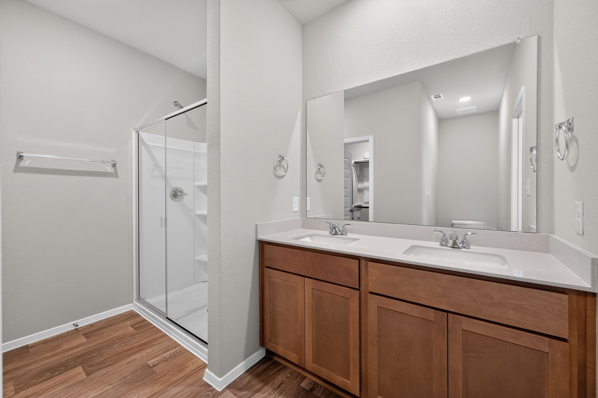 2704 Towy Road Manor, TX 78653 - Photo 8 of 36 Clean lines and a spacious dual vanity define this modern, comfortable bathroom space.