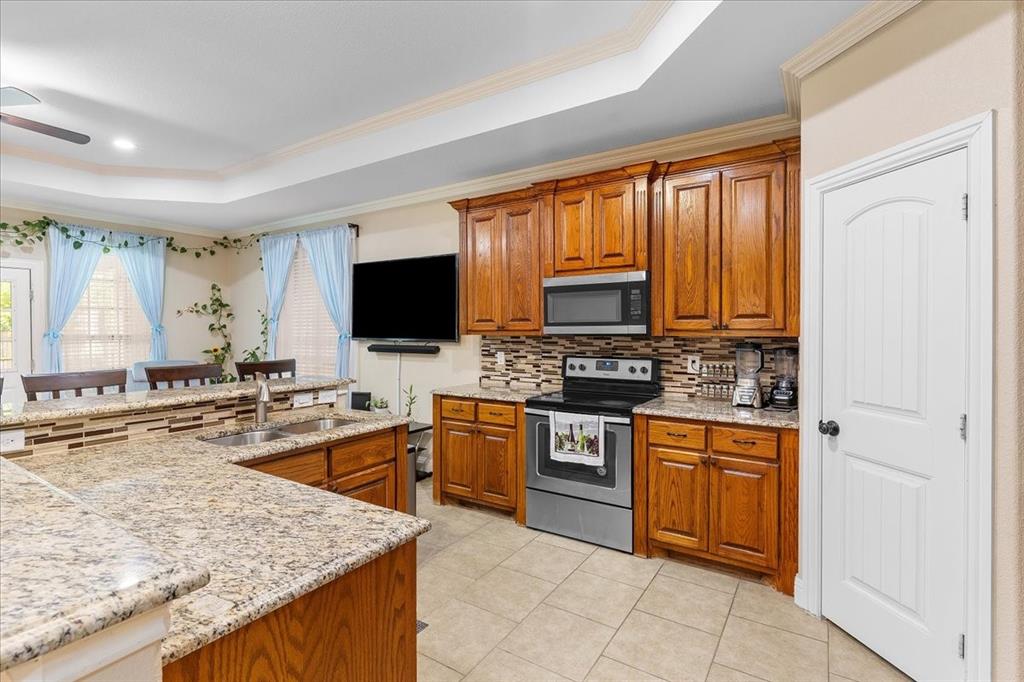 502 Ritchey Street Gainesville, TX 76240 - Photo 10 of 29 a kitchen with stainless steel appliances granite countertop a stove microwave and sink