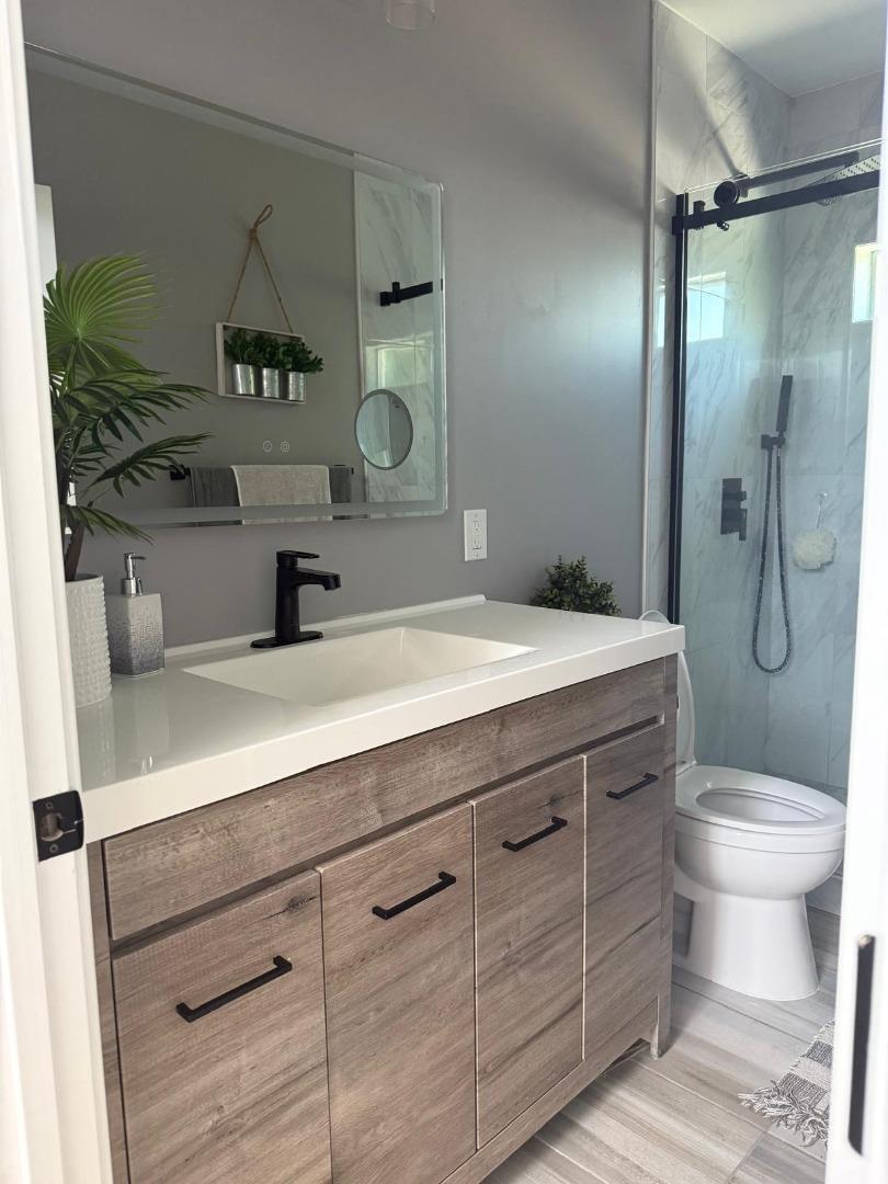 1170 Cotter Way Hayward, CA 94541 - Photo 11 of 18 a bathroom with a sink a toilet and shower