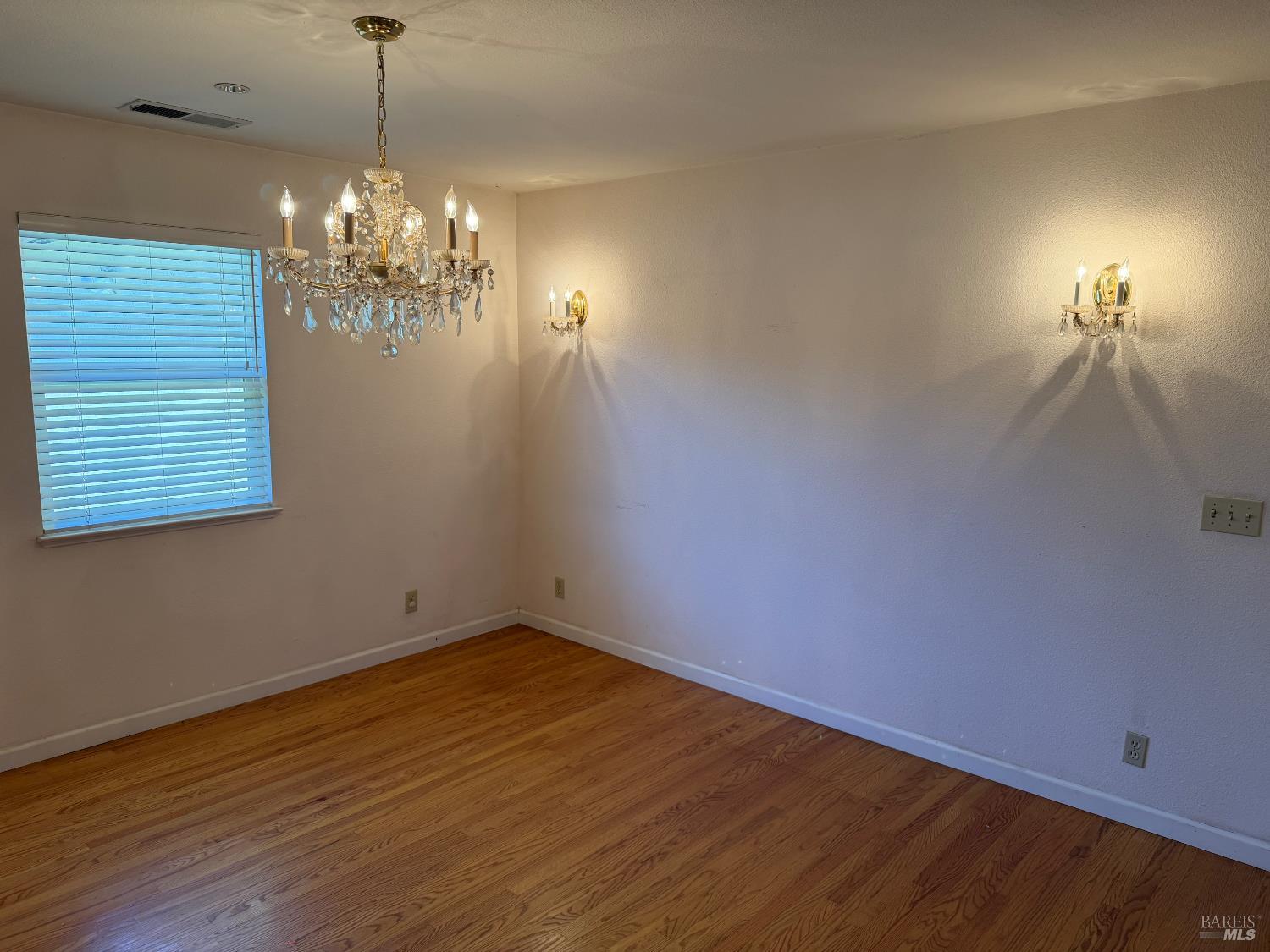 1927 Marsh Road Santa Rosa, CA 95403 - Photo 11 of 31 a view of a room with wooden floor and chandelier