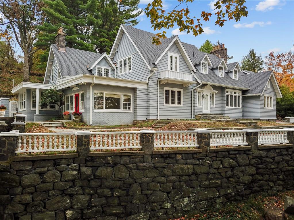 a front view of a house with a lots of space and a car parked