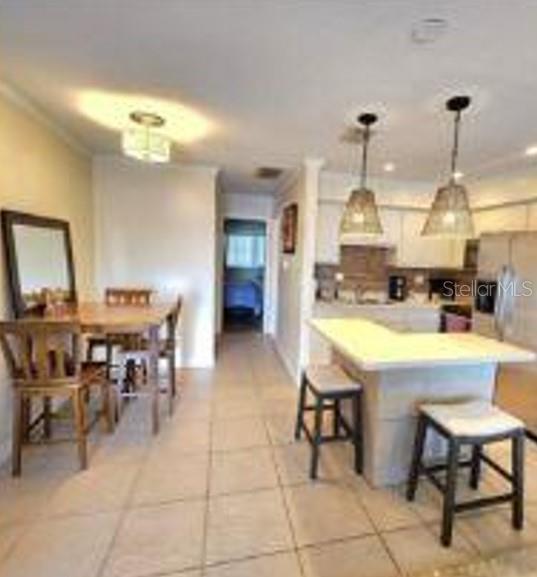 525 Manatee Court, Unit 13 Venice, FL 34285 - Photo 6 of 7 a view of kitchen with sink dining table and chairs