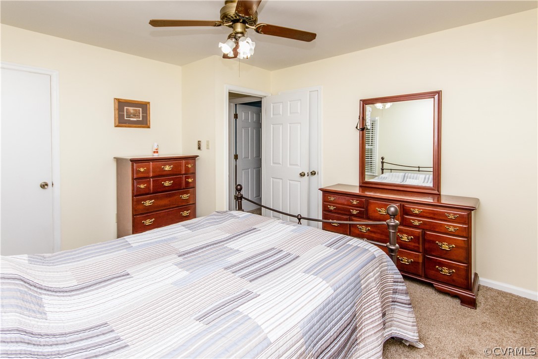 13404 Scotts Road Dewitt, VA 23840 - Photo 30 of 31 a bedroom with a bed and a chandelier