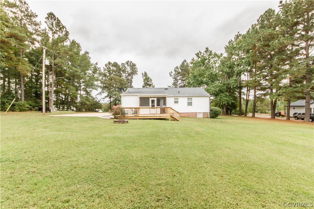 13404 Scotts Road Dewitt, VA 23840 - Photo 7 of 31 a front view of a house with a garden and trees