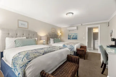 a bed room with a bed and a chair