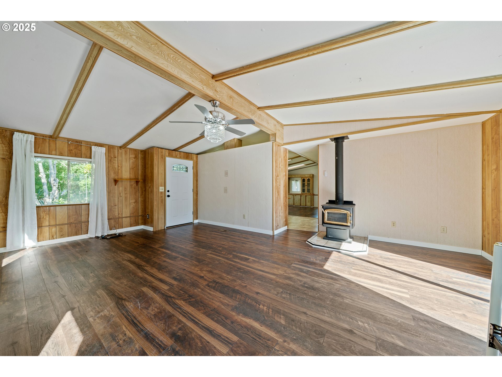 1057 Northeast 12th Avenue Rockaway Beach, OR 97136 - Photo 12 of 36 a view of an empty room with wooden floor and a window