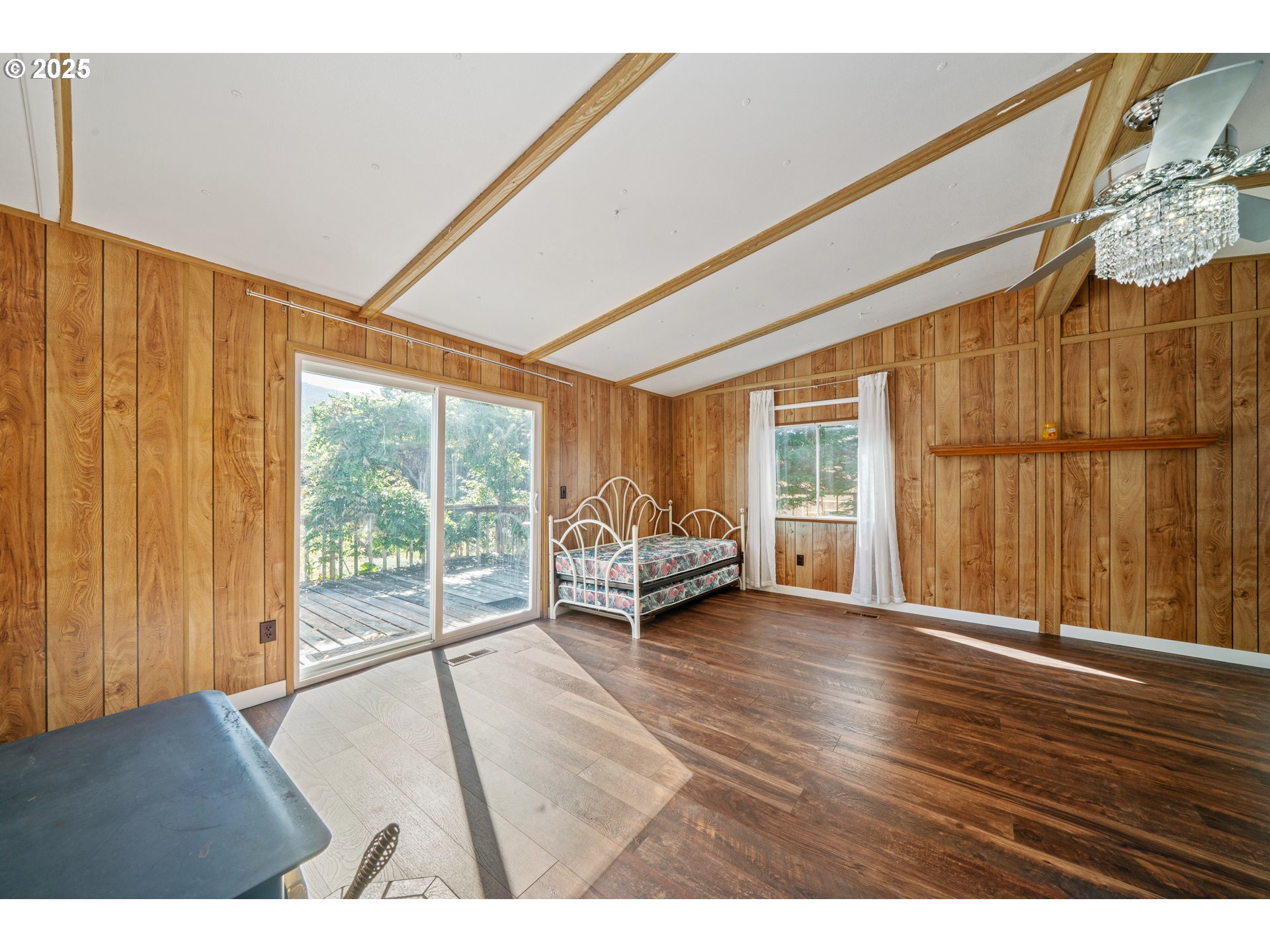 1057 Northeast 12th Avenue Rockaway Beach, OR 97136 - Photo 15 of 36 a living room with furniture and a floor to ceiling window