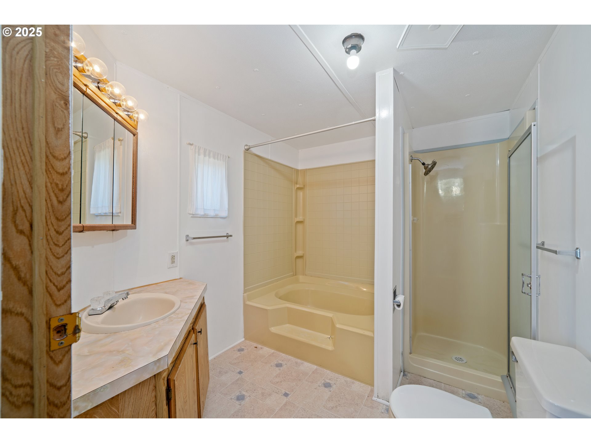 1057 Northeast 12th Avenue Rockaway Beach, OR 97136 - Photo 22 of 36 a bathroom with a sink a toilet and shower