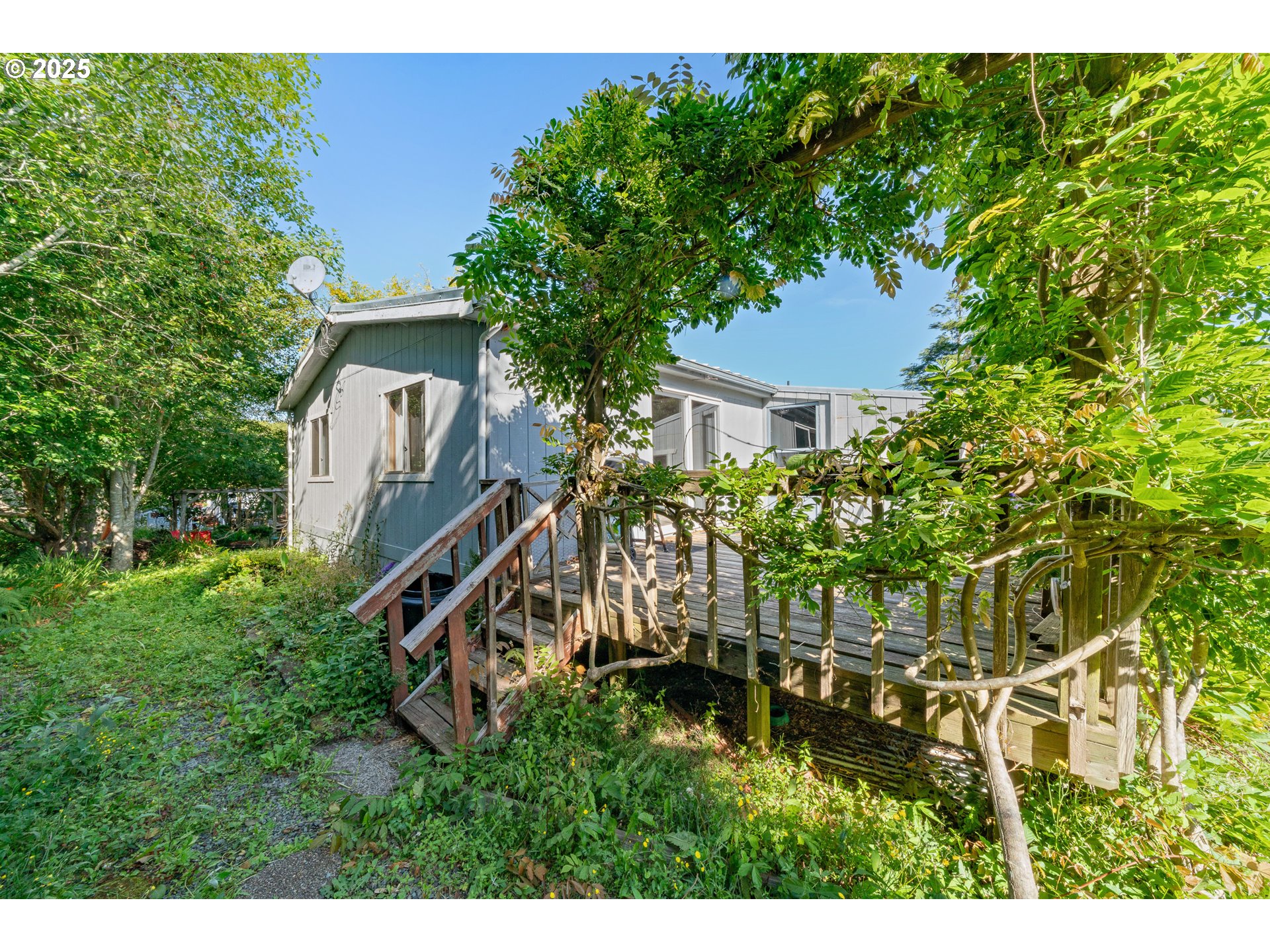 1057 Northeast 12th Avenue Rockaway Beach, OR 97136 - Photo 26 of 36 a yellow house with trees in front of it