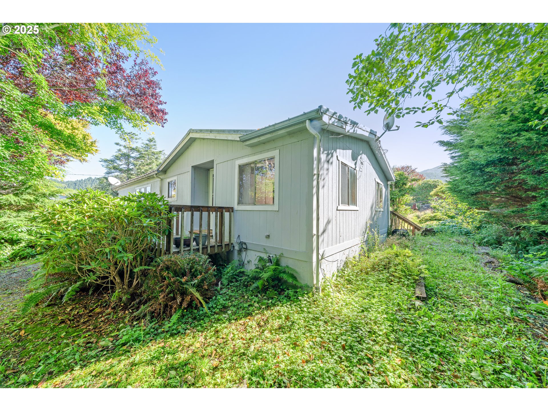 1057 Northeast 12th Avenue Rockaway Beach, OR 97136 - Photo 28 of 36 a front view of a house with a yard