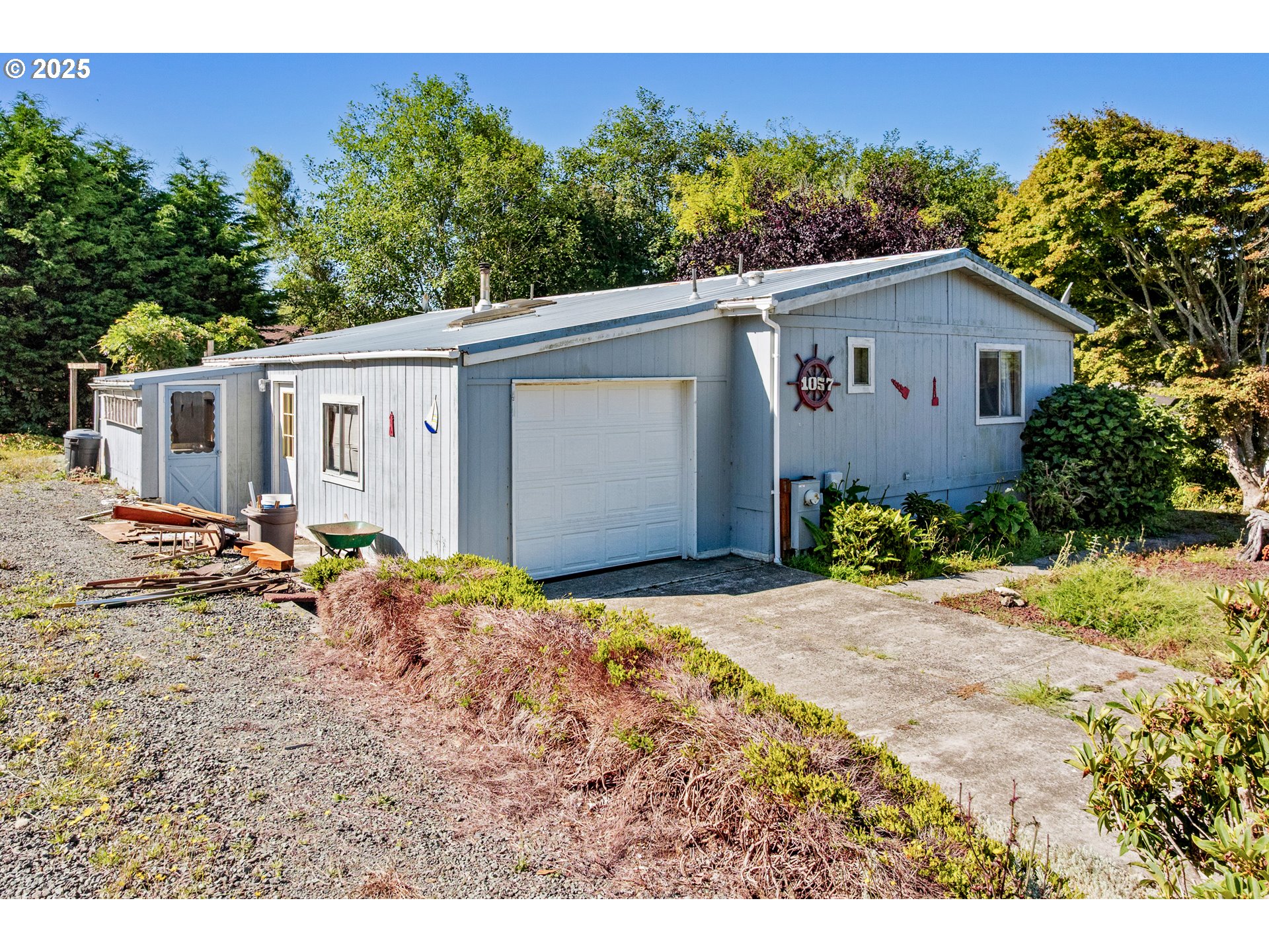 1057 Northeast 12th Avenue Rockaway Beach, OR 97136 - Photo 5 of 36 a backyard of a house with plants and trees