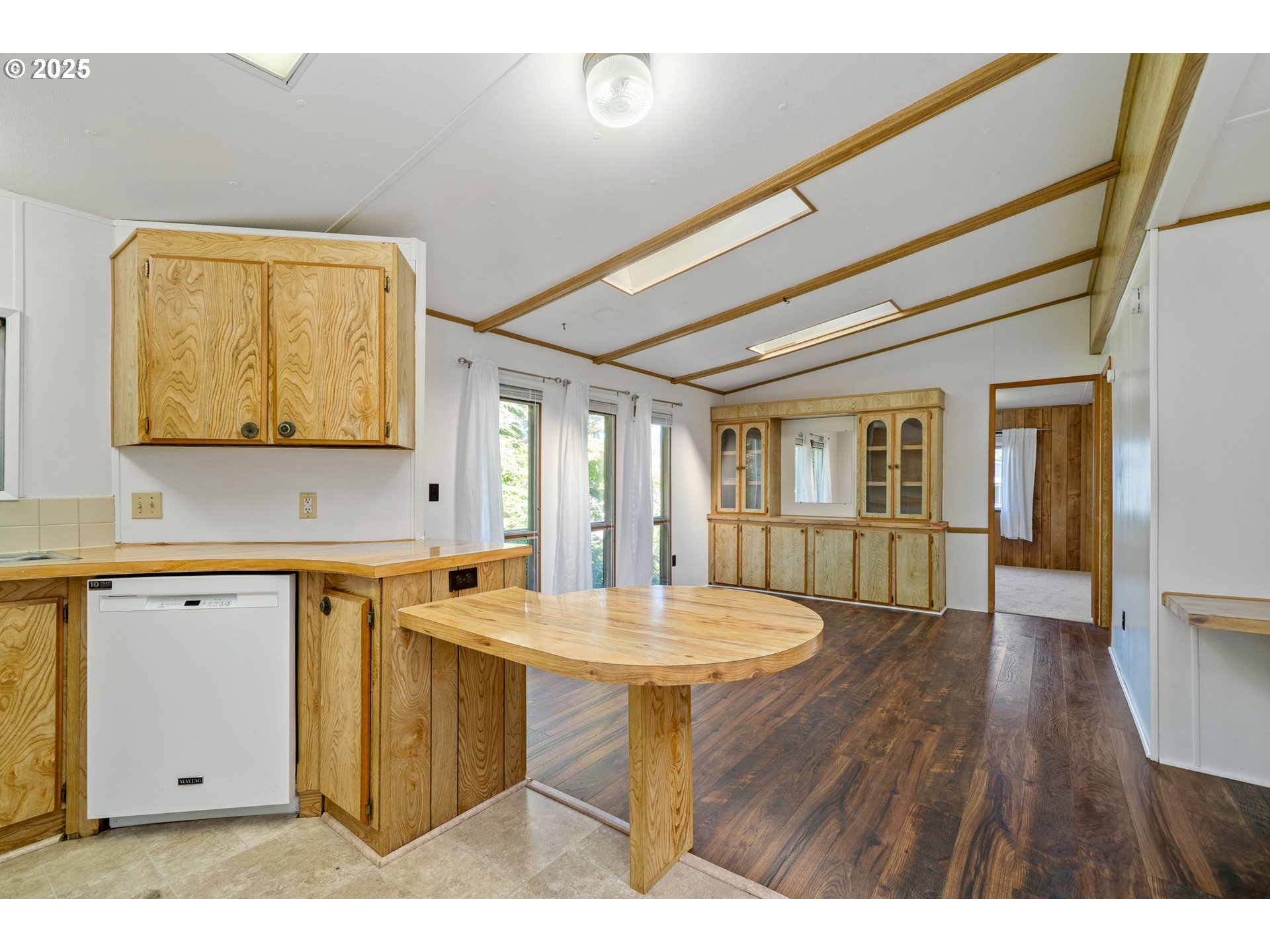 1057 Northeast 12th Avenue Rockaway Beach, OR 97136 - Photo 9 of 36 a view of a kitchen area with furniture and wooden floor