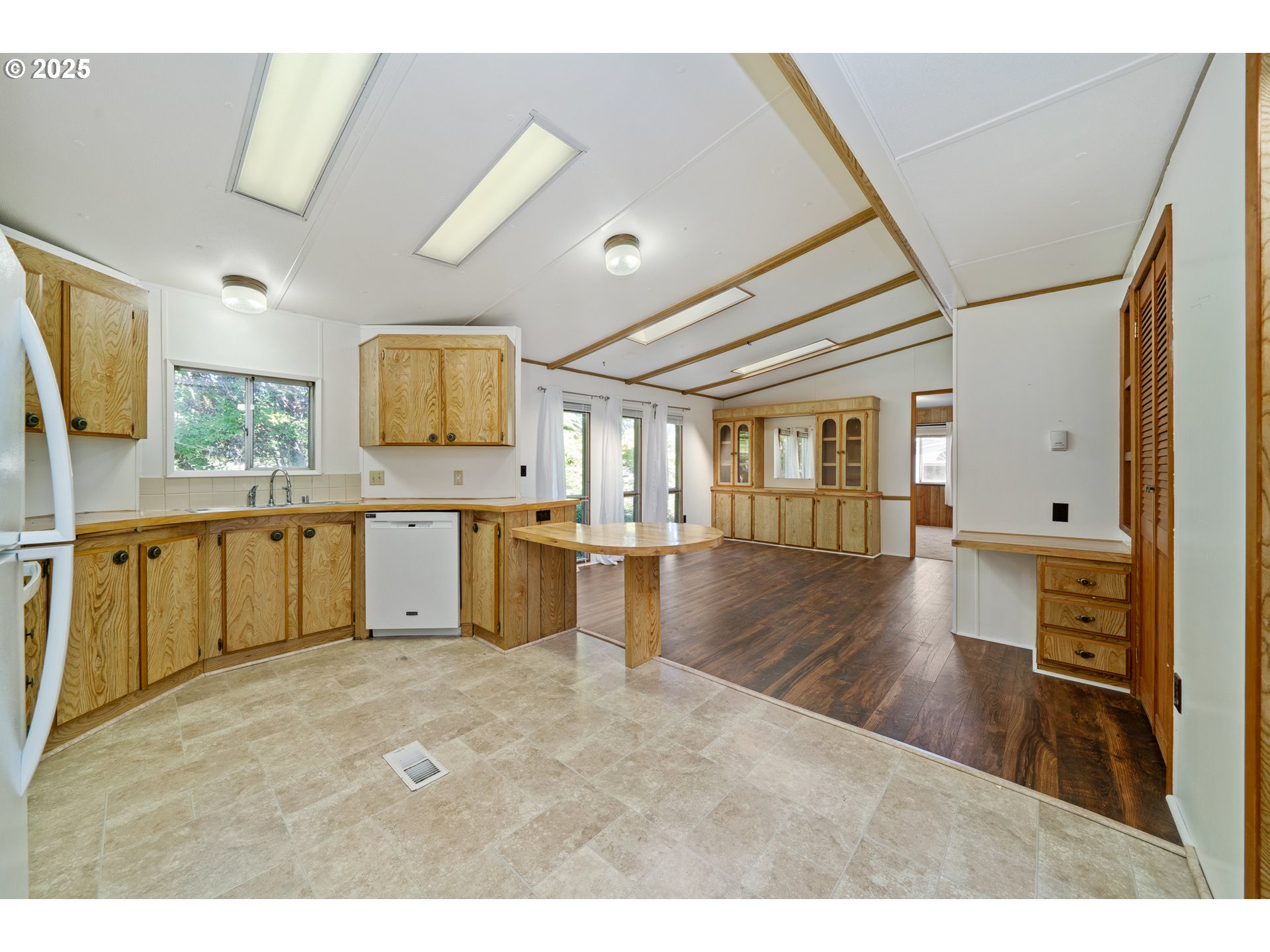 1057 Northeast 12th Avenue Rockaway Beach, OR 97136 - Photo 10 of 36 a kitchen with granite countertop a stove top oven a sink a dining table and chairs