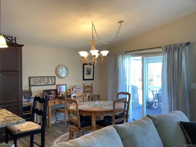 a living room with furniture a window and a chandelier