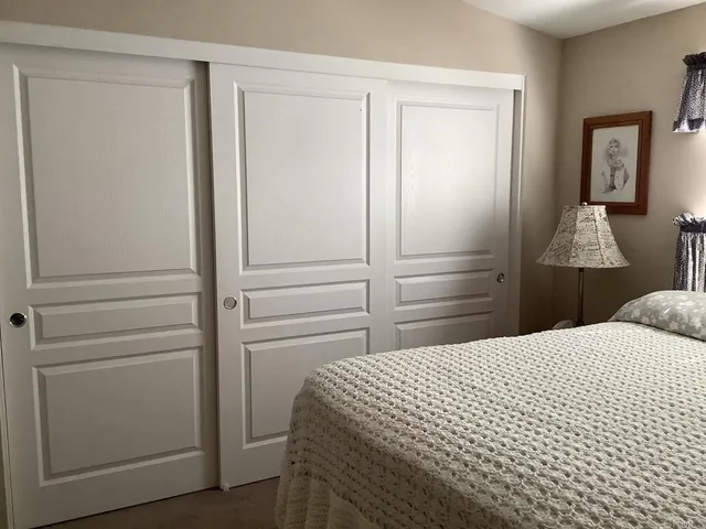 a bedroom with a bed and a closet