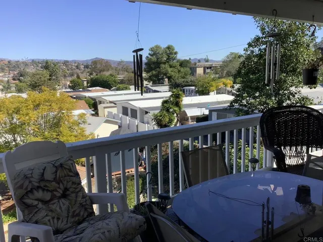 a view of a balcony with mountain view and wooden floor