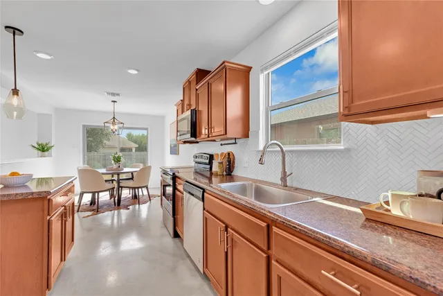 a view of a dining room with a table and chairs