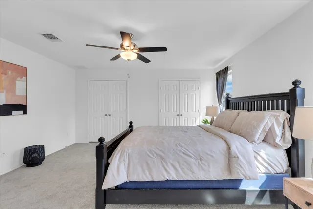 a bathroom with a double vanity sink mirror and toilet
