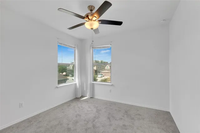 a bathroom with a double vanity sink and toilet