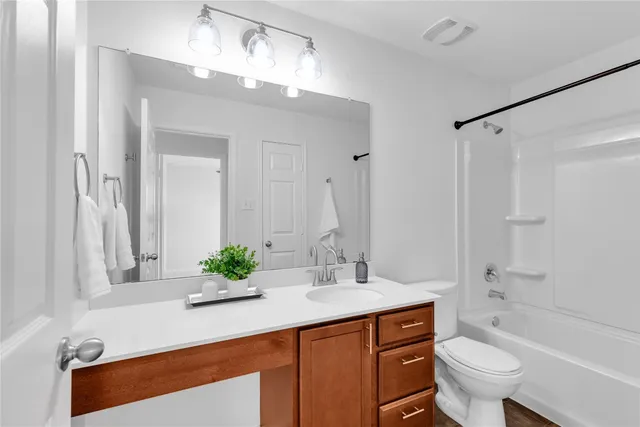 a view of a house with wooden fence