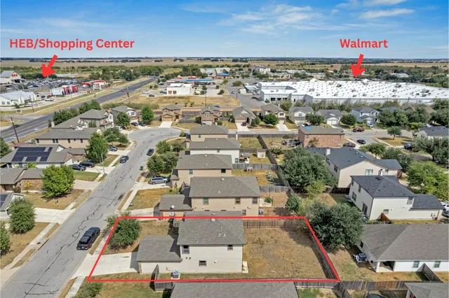 an aerial view of a house with a yard