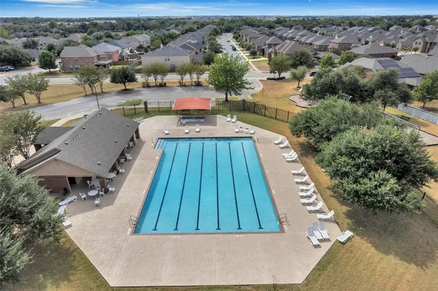 an aerial view of a house with a yard and lake view