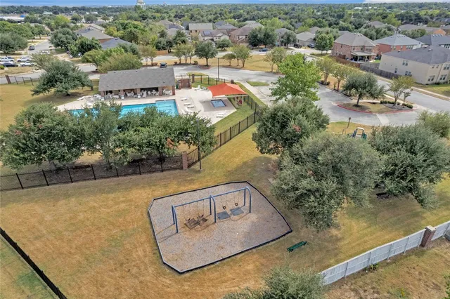 an aerial view of a house with yard swimming pool and outdoor seating